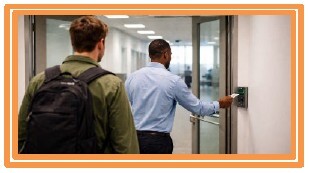 A man holding the door open for another man.